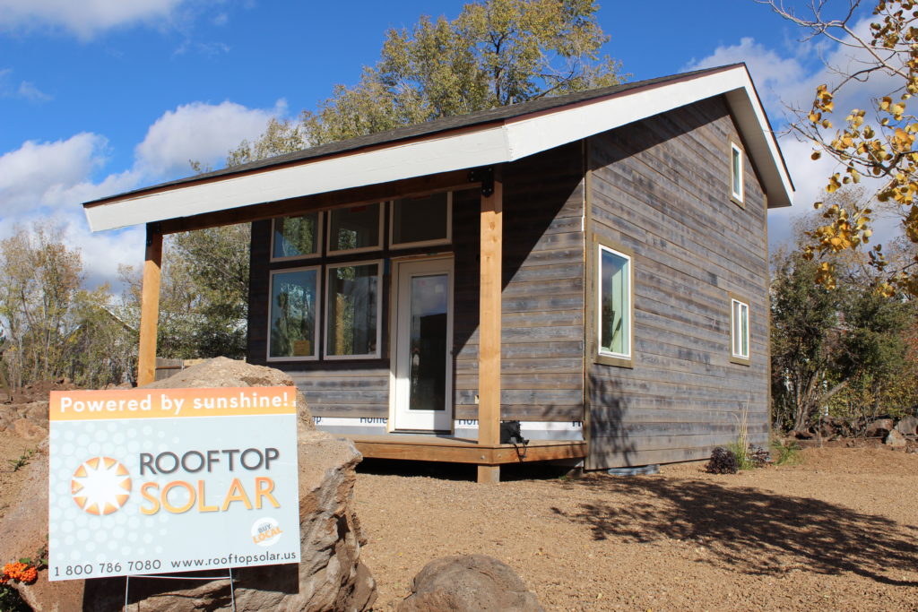 Rooftop Solar sign in front of Habitat for new Humanity house in Flagtaff Arizona 